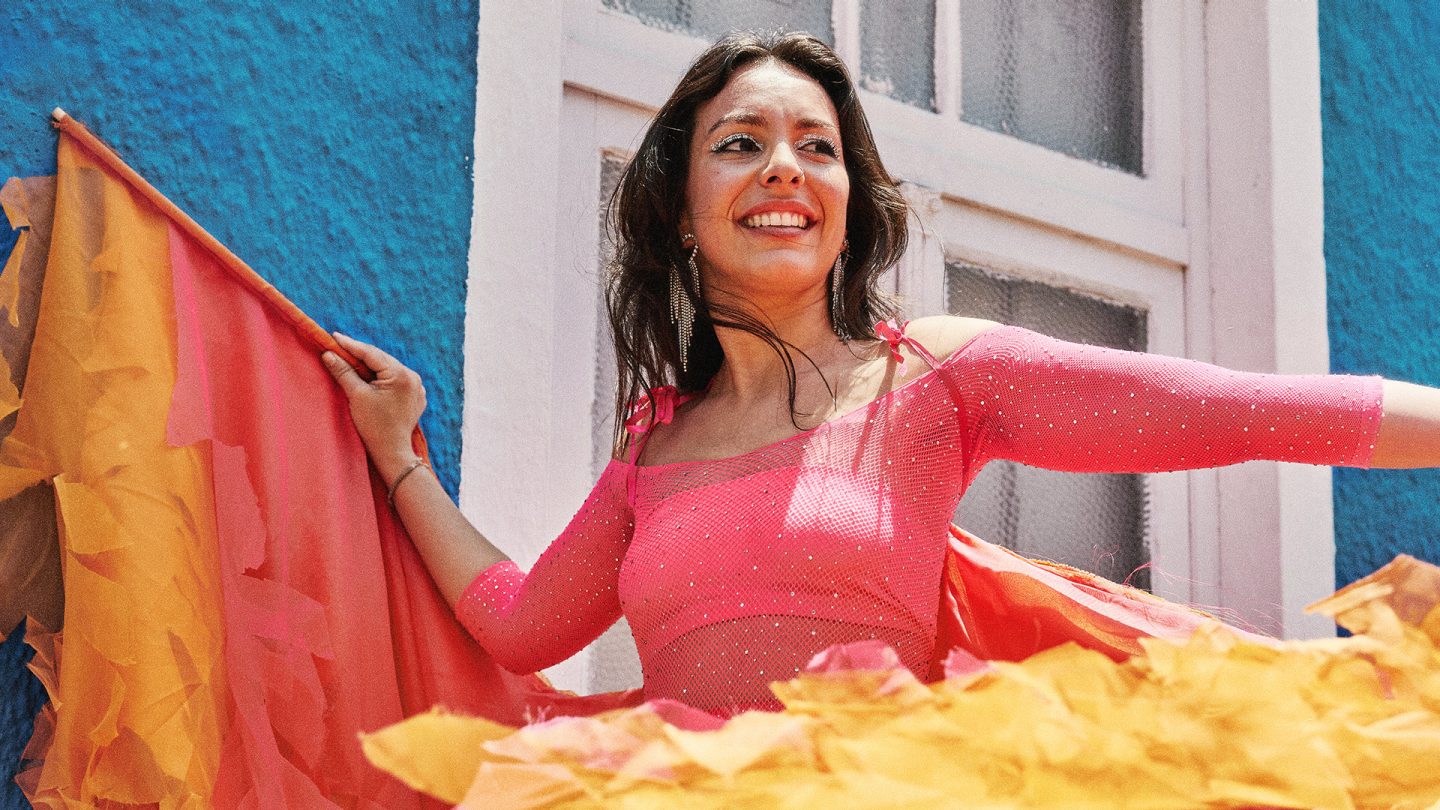 A woman in a colorful costume at carnival.