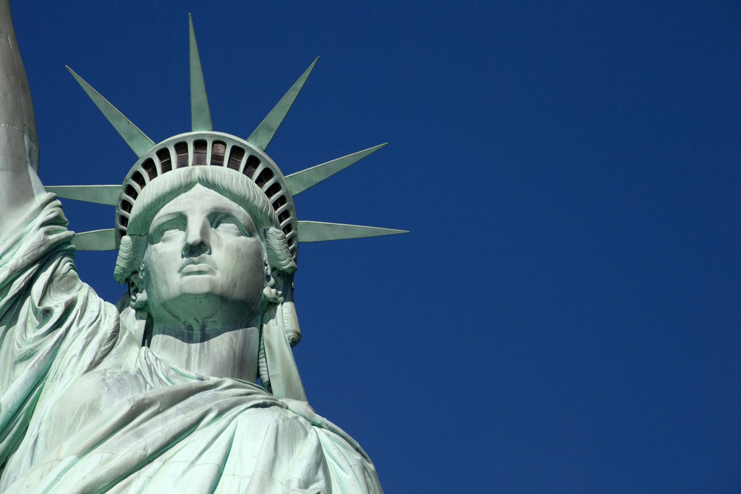 Statue of Liberty in front of the blue sky