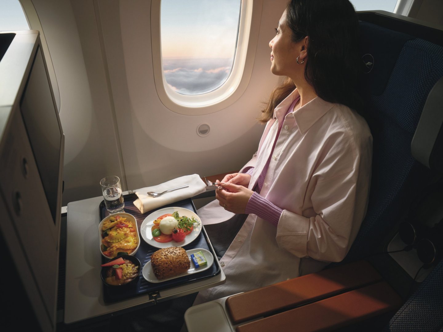 A passenger enjoying a fresh vegetarian meal during a flight.
