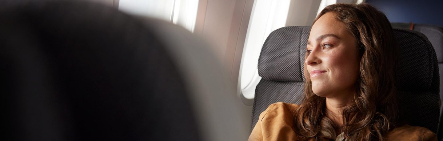 A woman sitting in an aircraft.