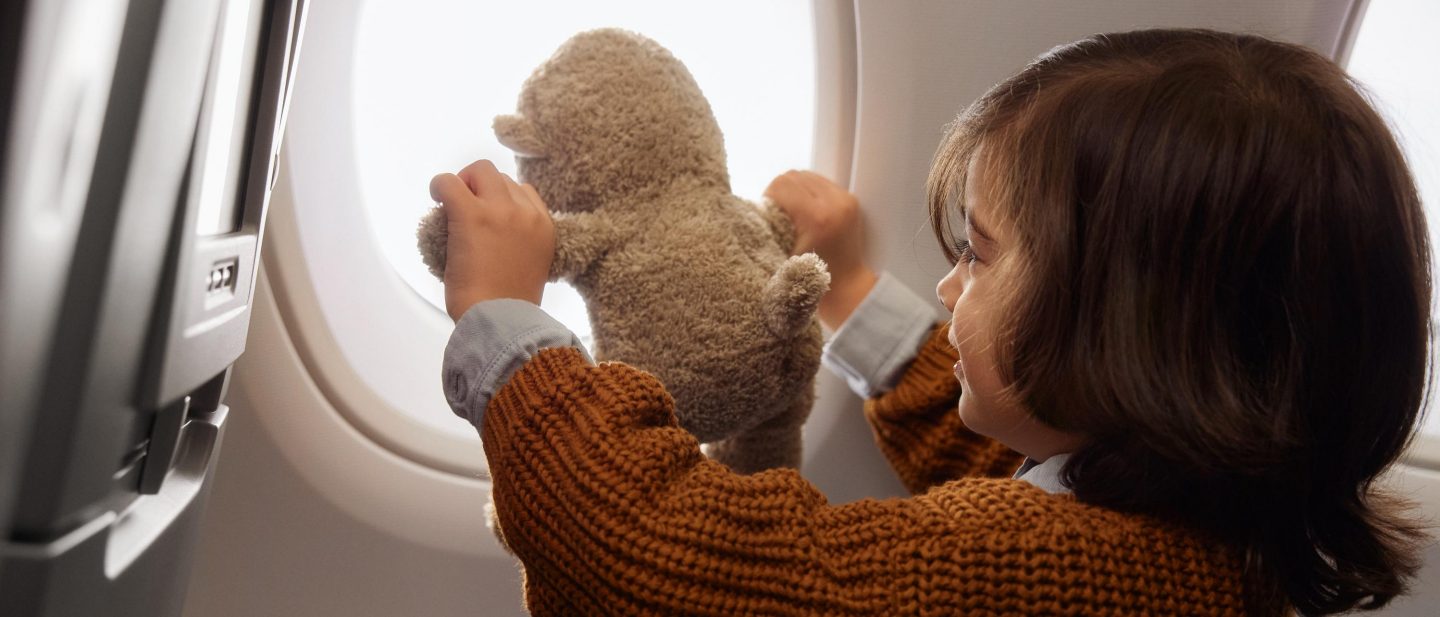 Nahaufnahme von Spielzeug mit Junge an Bord der Economy Class. // Close up of toy with boy on board of economy class.