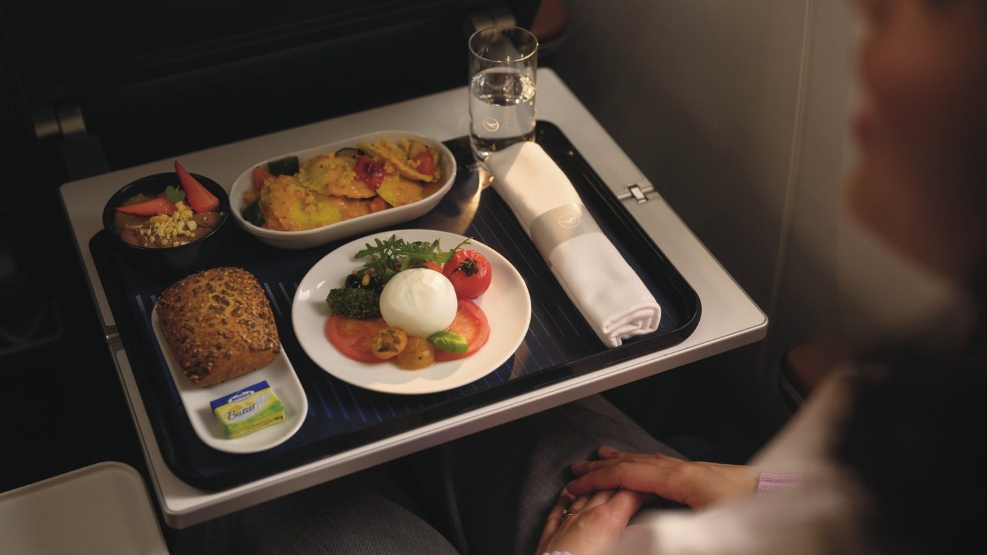 A passenger looking at culinary options on the Lufthansa app before their flight.
