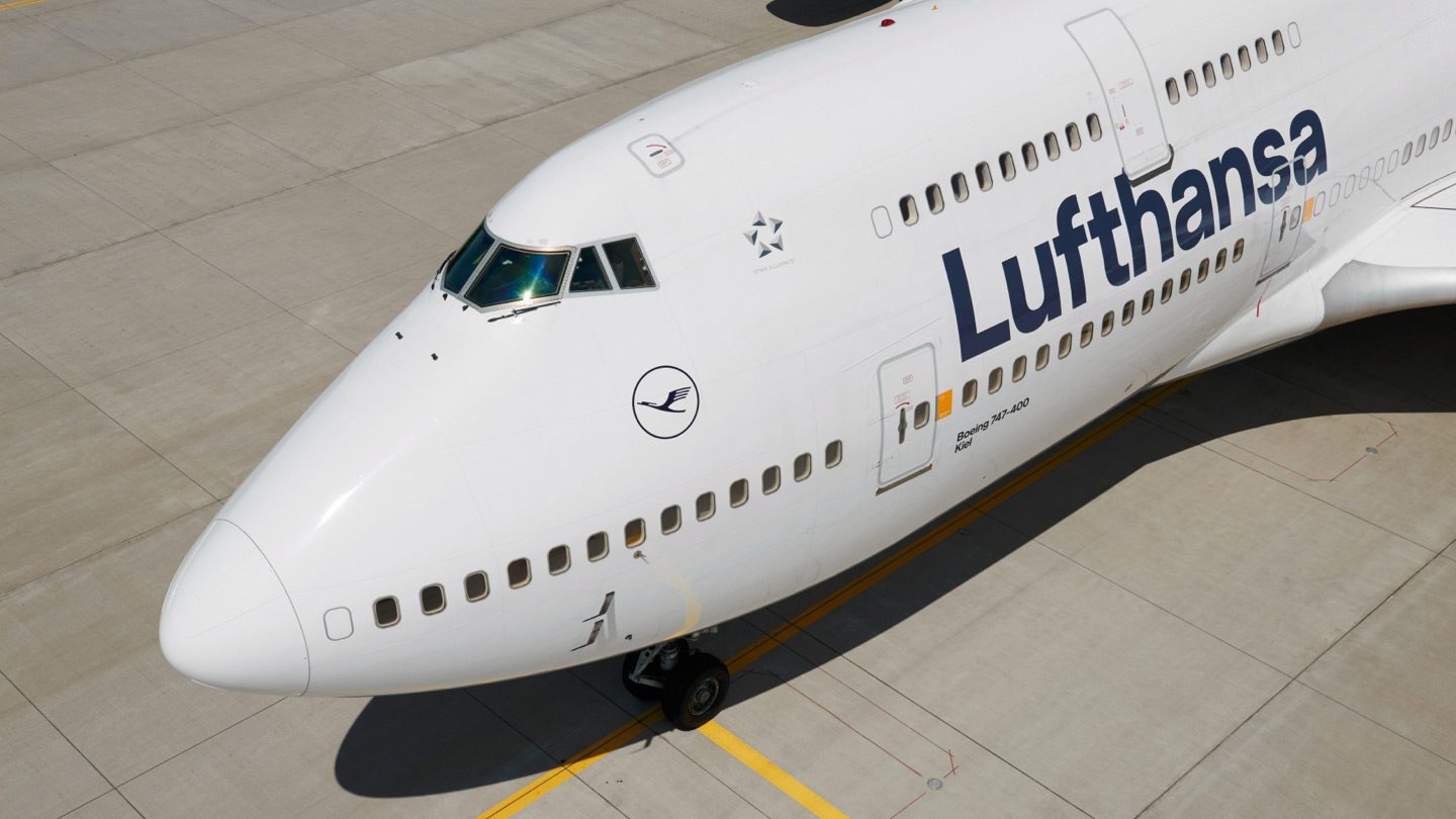 Close-up of a Lufthansa Boeing 747-400 parked on the tarmac.