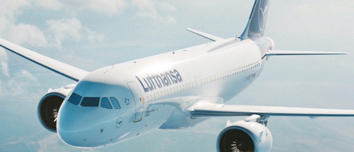 Lufthansa airplane in flight against a blue sky with light clouds.