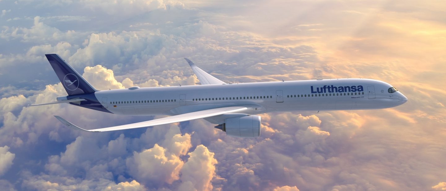 Lufthansa A350-1000 plane flying over sun-drenched clouds.