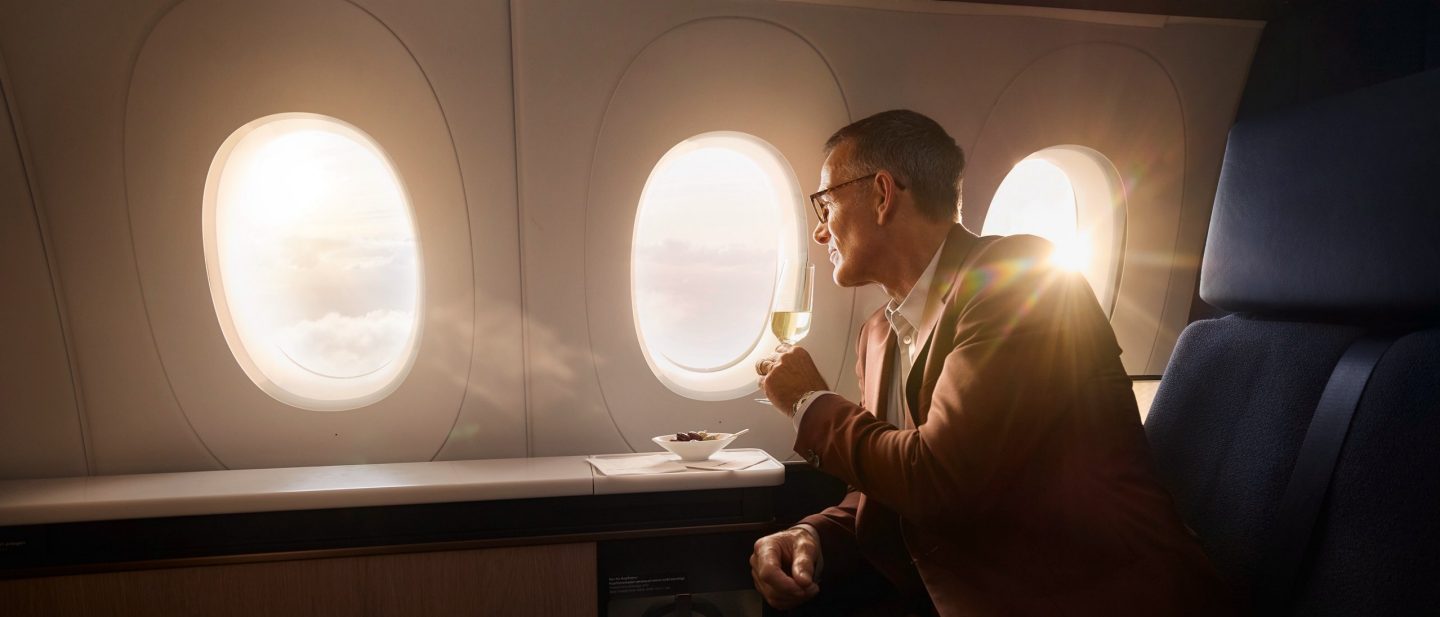 Passenger looking out an airplane window, with the Skytrax 2026 award logo.