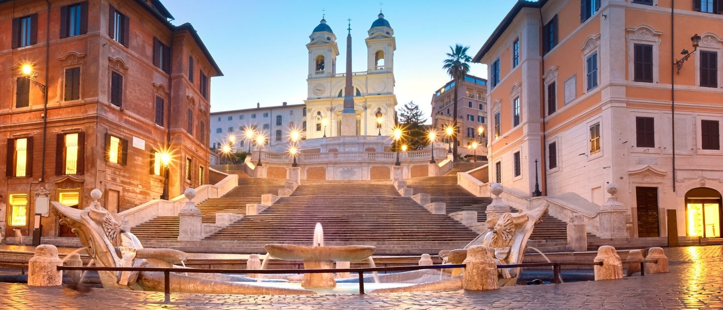 Spanish Steps and a boat-shaped fountain on Piazza di Spagna in Rome, Italy. Early morning panoramic shot after rain