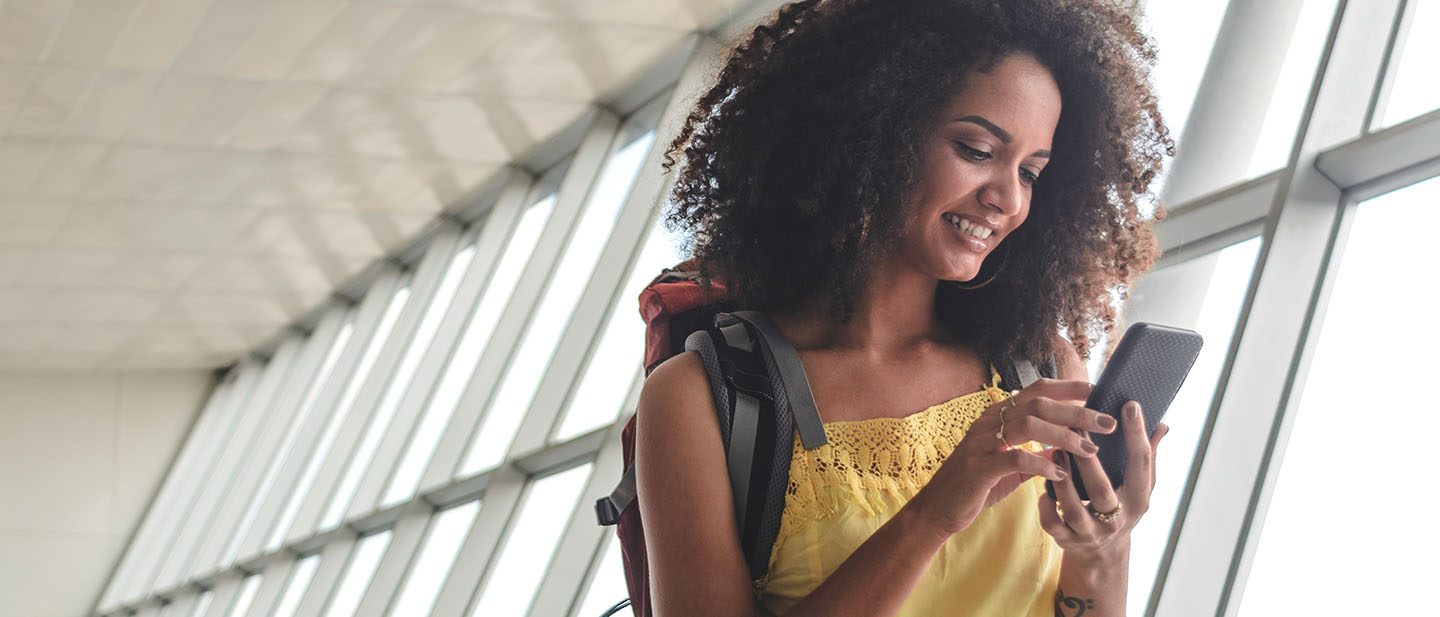 Woman gets information on her cell phone at the airport.