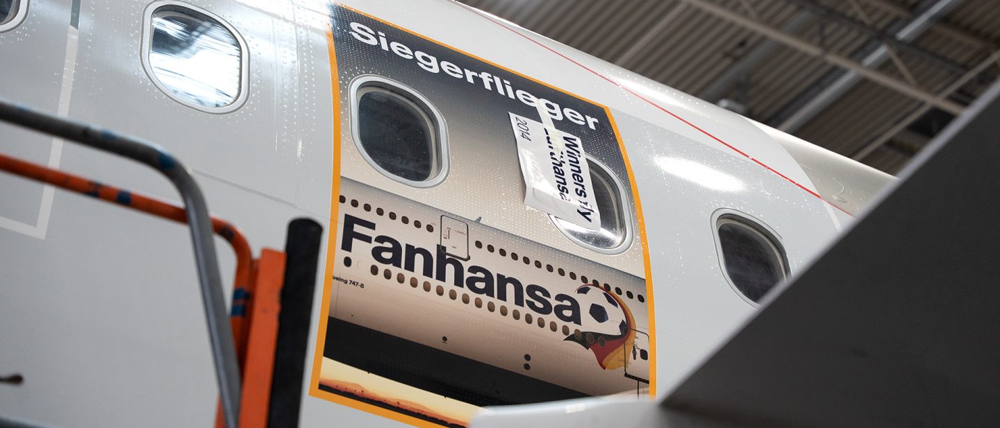Close-up of aircraft livery with “Fanhansa” lettering and soccer motif on fuselage.
