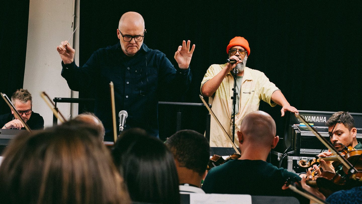 Concert rehearsal with rapper Samy Deluxe, the conductor, and the orchestra.