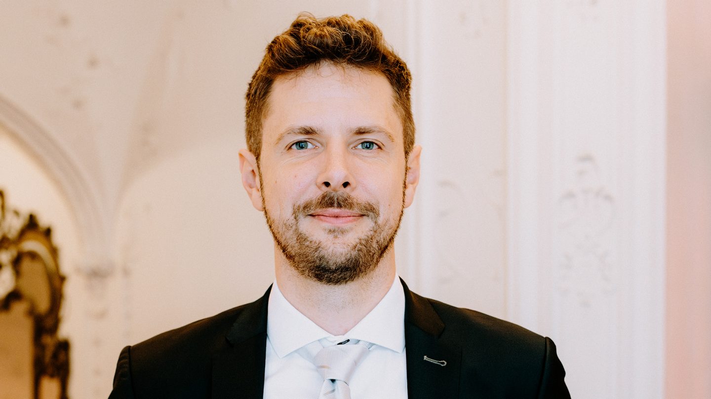 Portrait of a man in a suit in the foyer of the Hamburg  Schauspielhaus