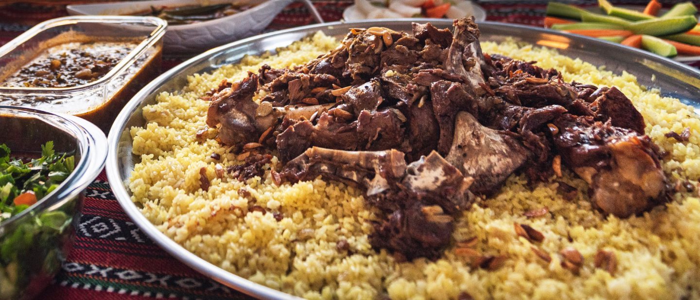Spiced meat on fragrant rice, served with side dishes