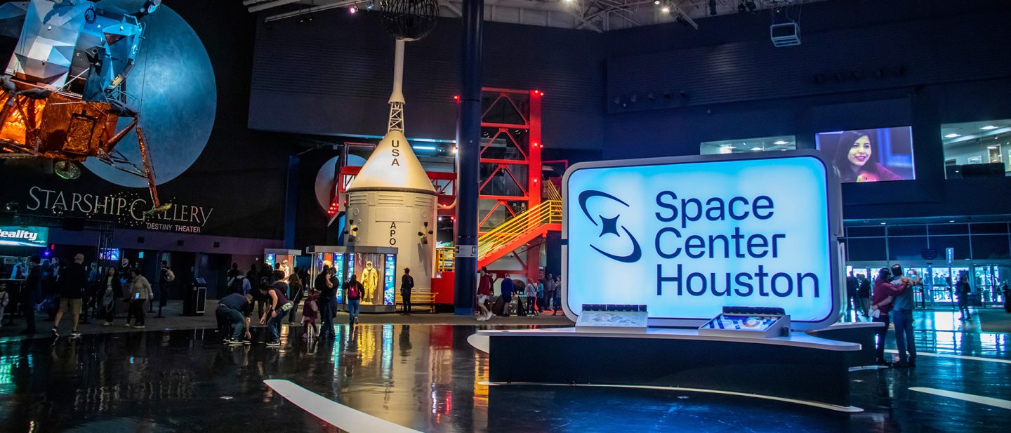 Visitors explore Space Center Houston, with exhibits of space capsules and lunar modules