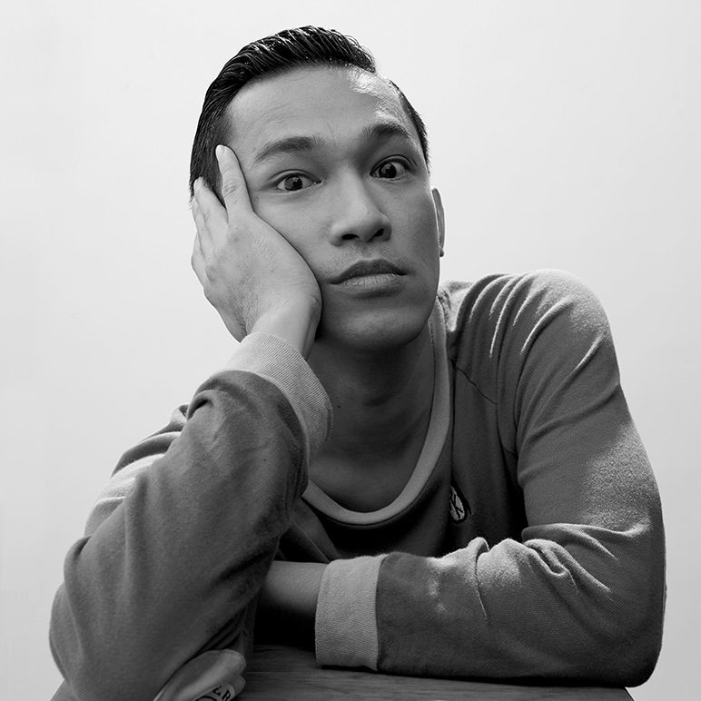 Black and white portrait of Note Pongsuang looking thoughtfully at the camera