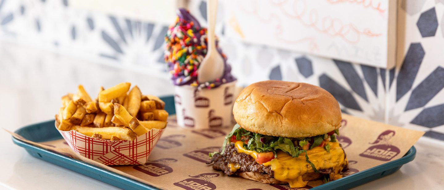 Photo of a cheeseburger with fries and ice cream in a casual dining setting.