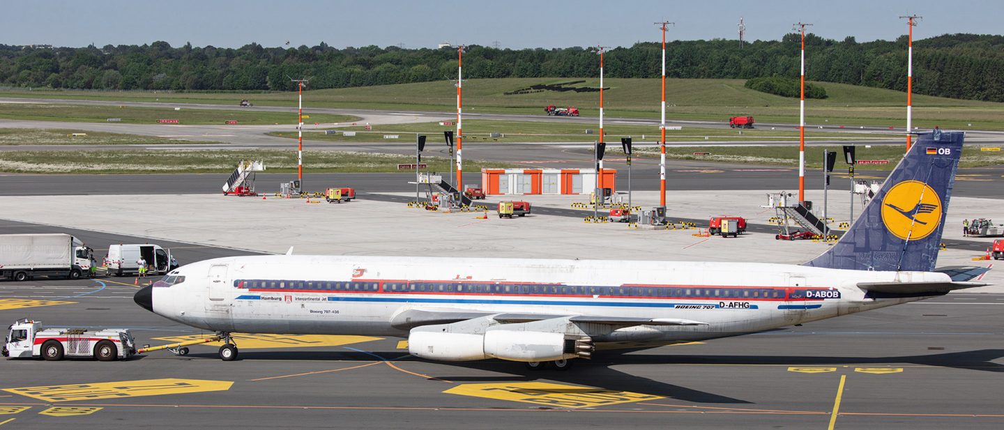 A historic Lufthansa airplane on the tarmac of an airport