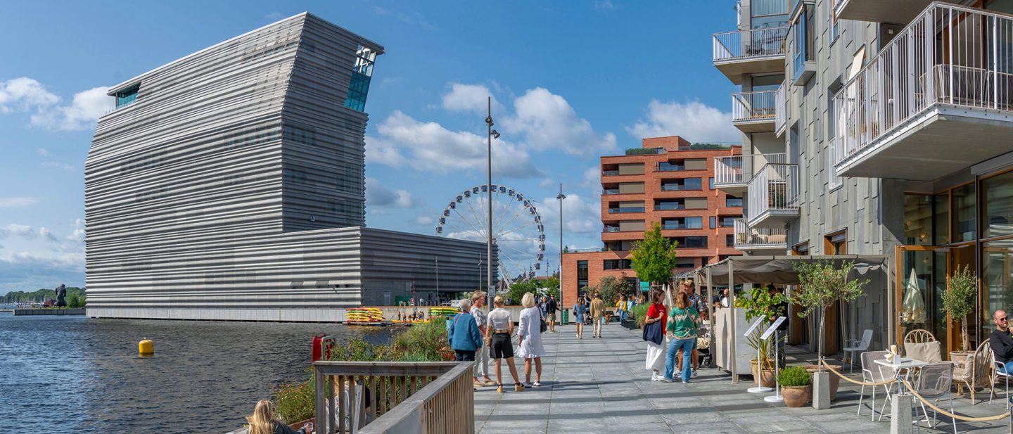Modern waterfront promenade in Oslo featuring the Munch Museum and a Ferris wheel