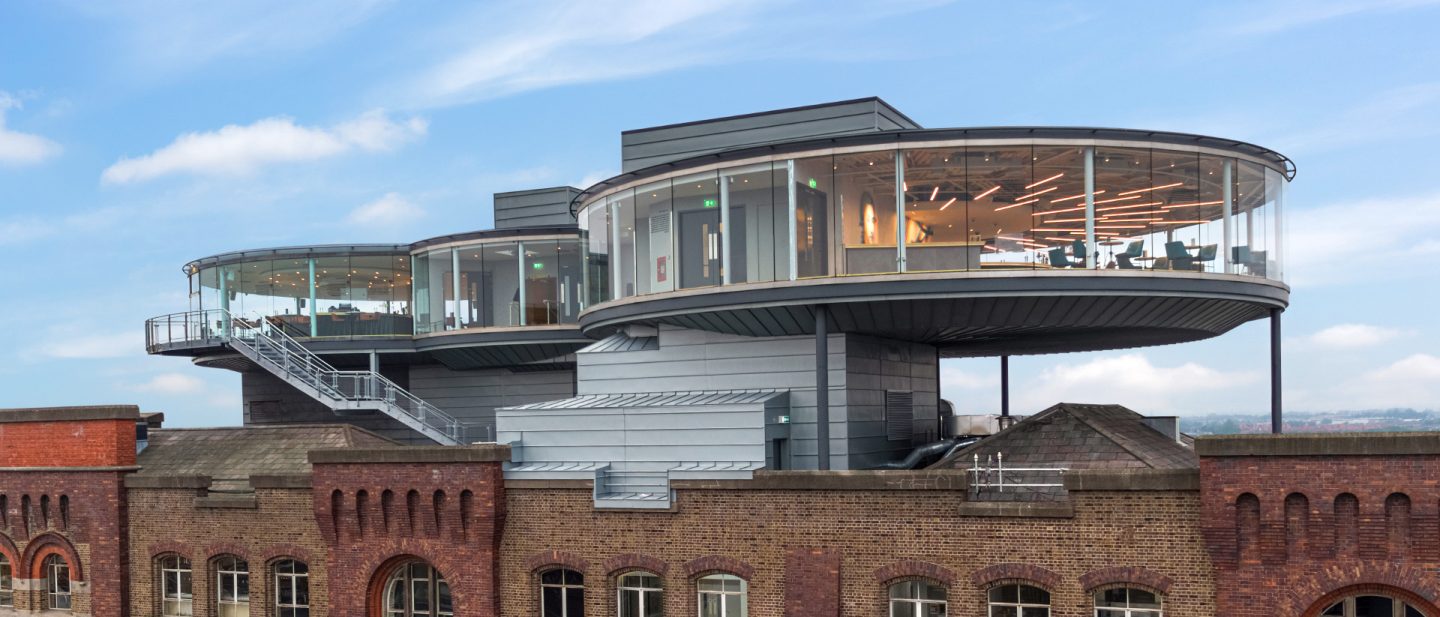 Modern glass structure on historic brick building in Dublin with panoramic view