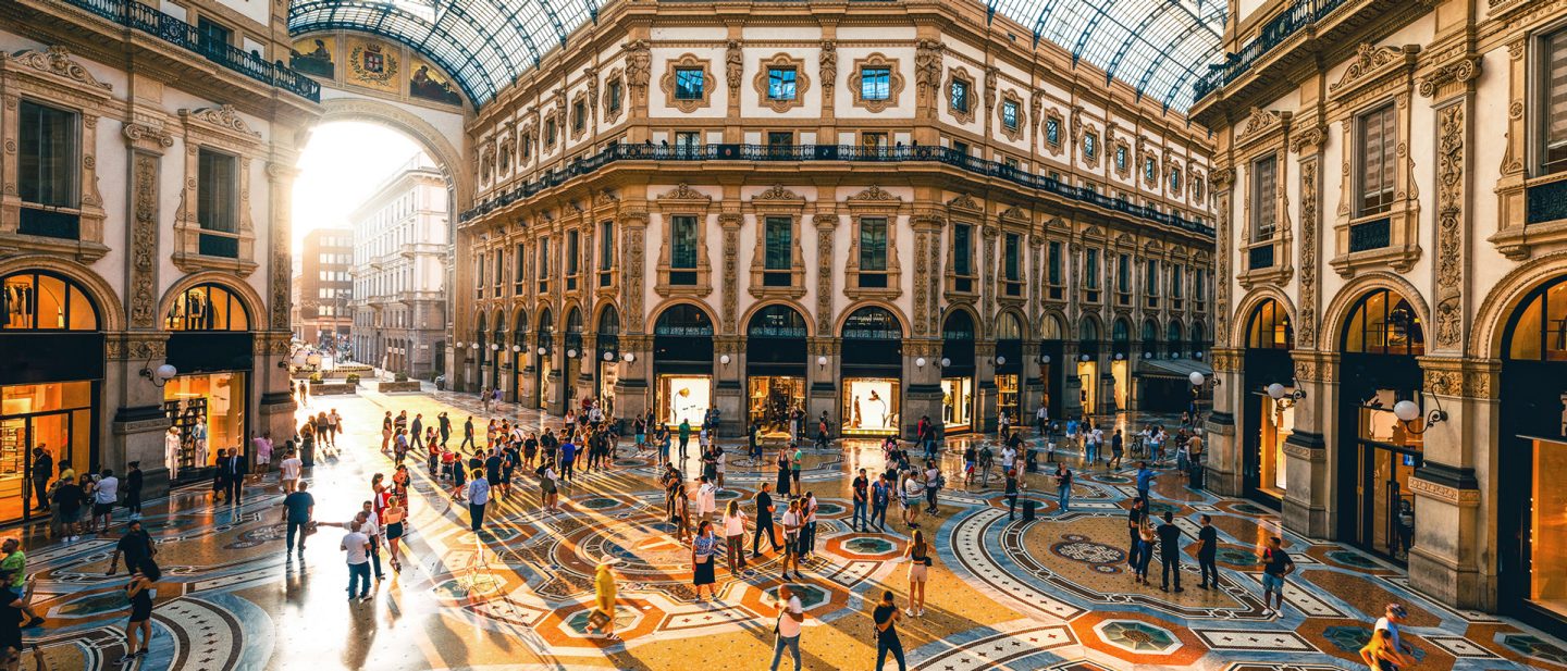 Galleria Vittorio Emanuele II in Milan with ornate flooring and people strolling