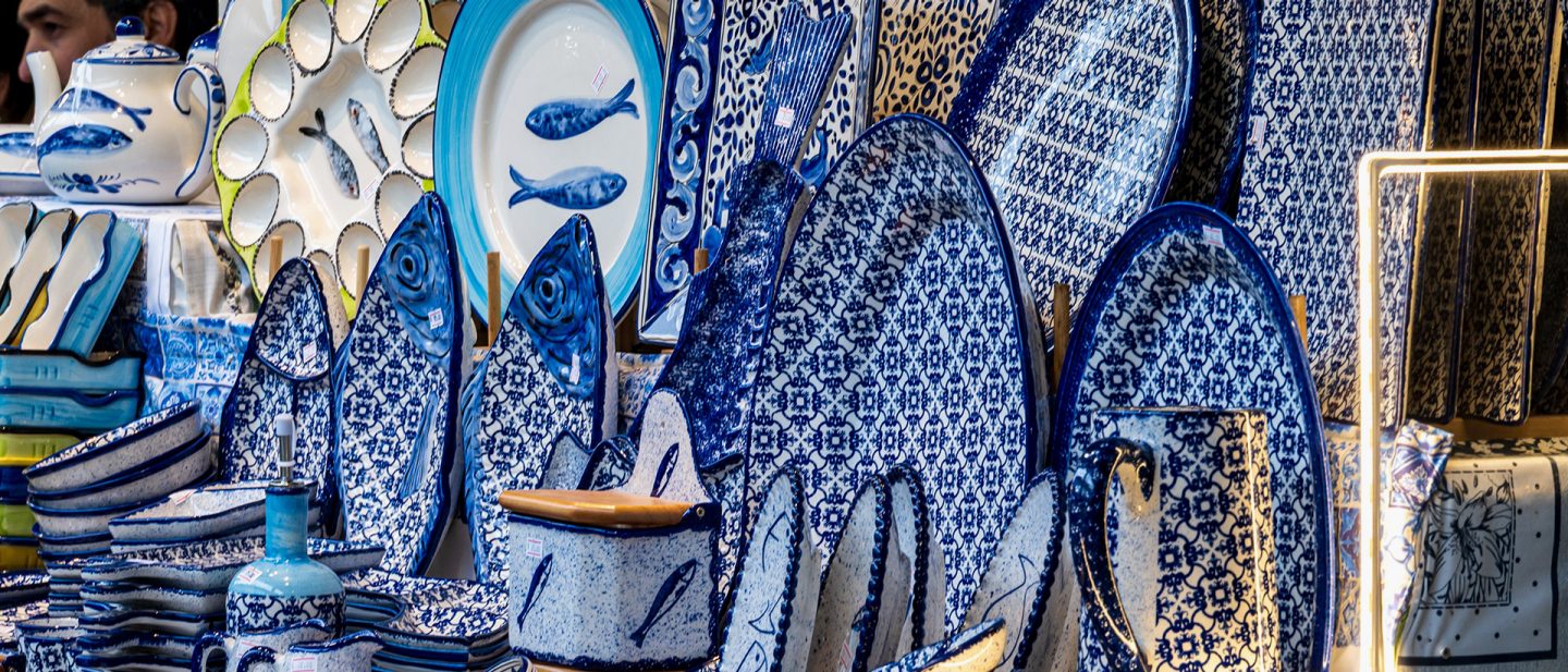 Blue and white Portuguese ceramics with fish motifs and traditional patterns