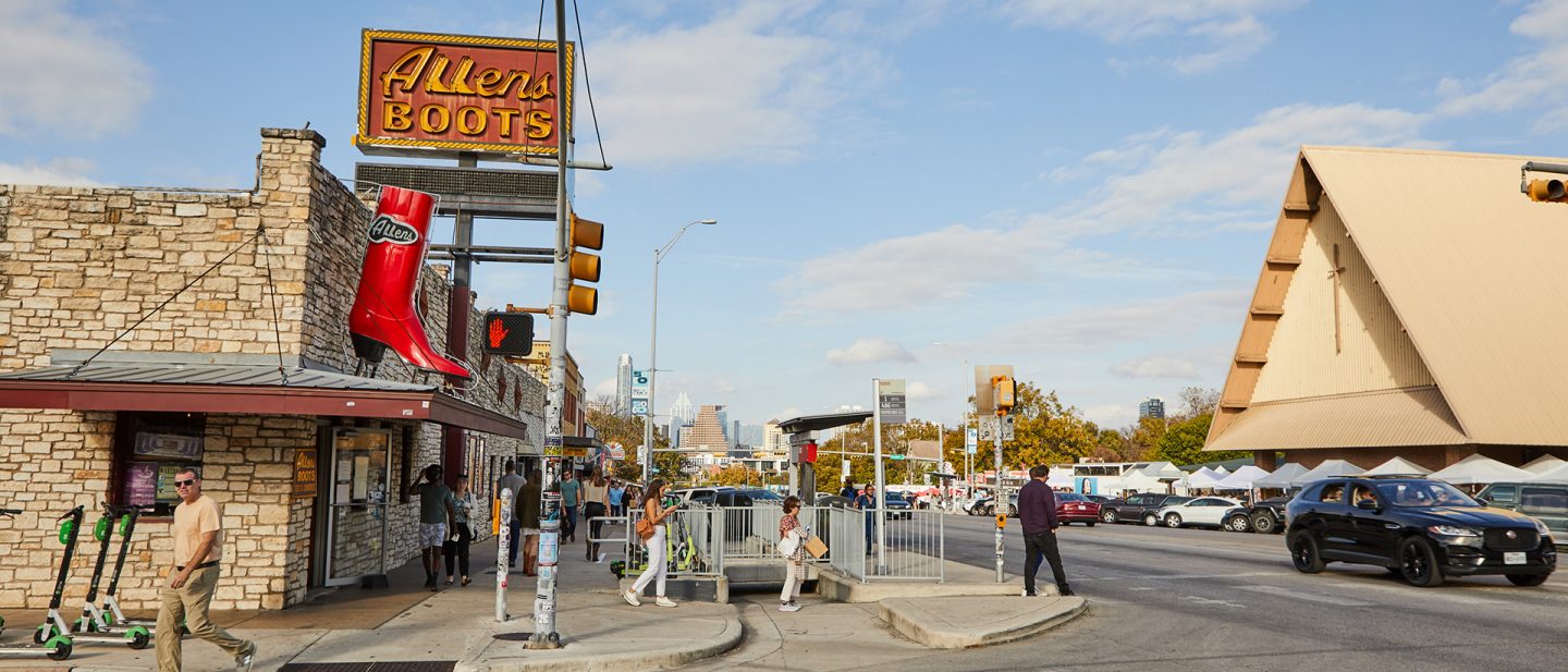 Allen's Boots store with large red boot sign on an urban street