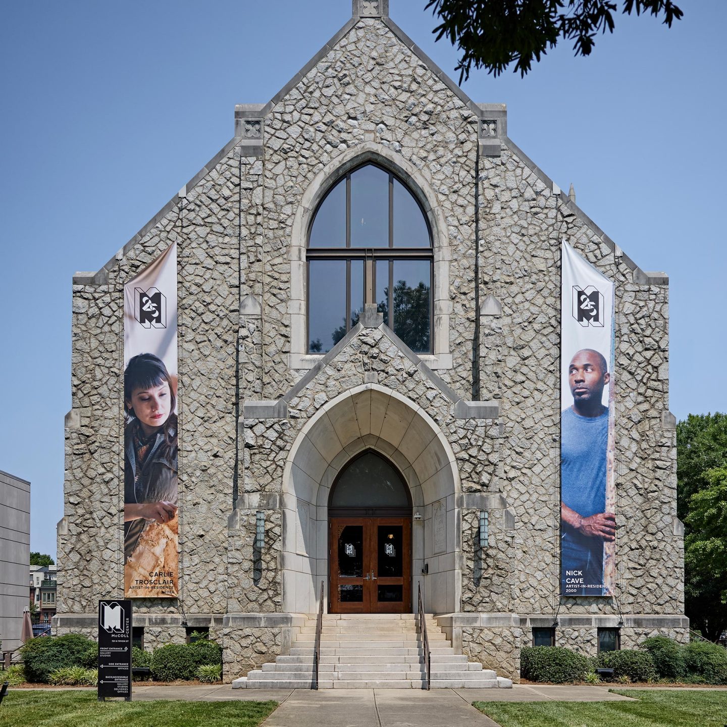 The McColl Center with Gothic entrance and two large portrait banners on the facade