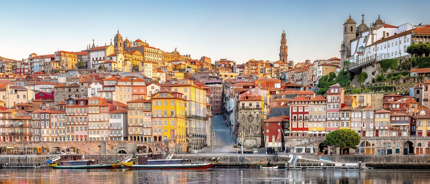 View of the colorful Ribeira district in Porto and traditional boats on the Douro River