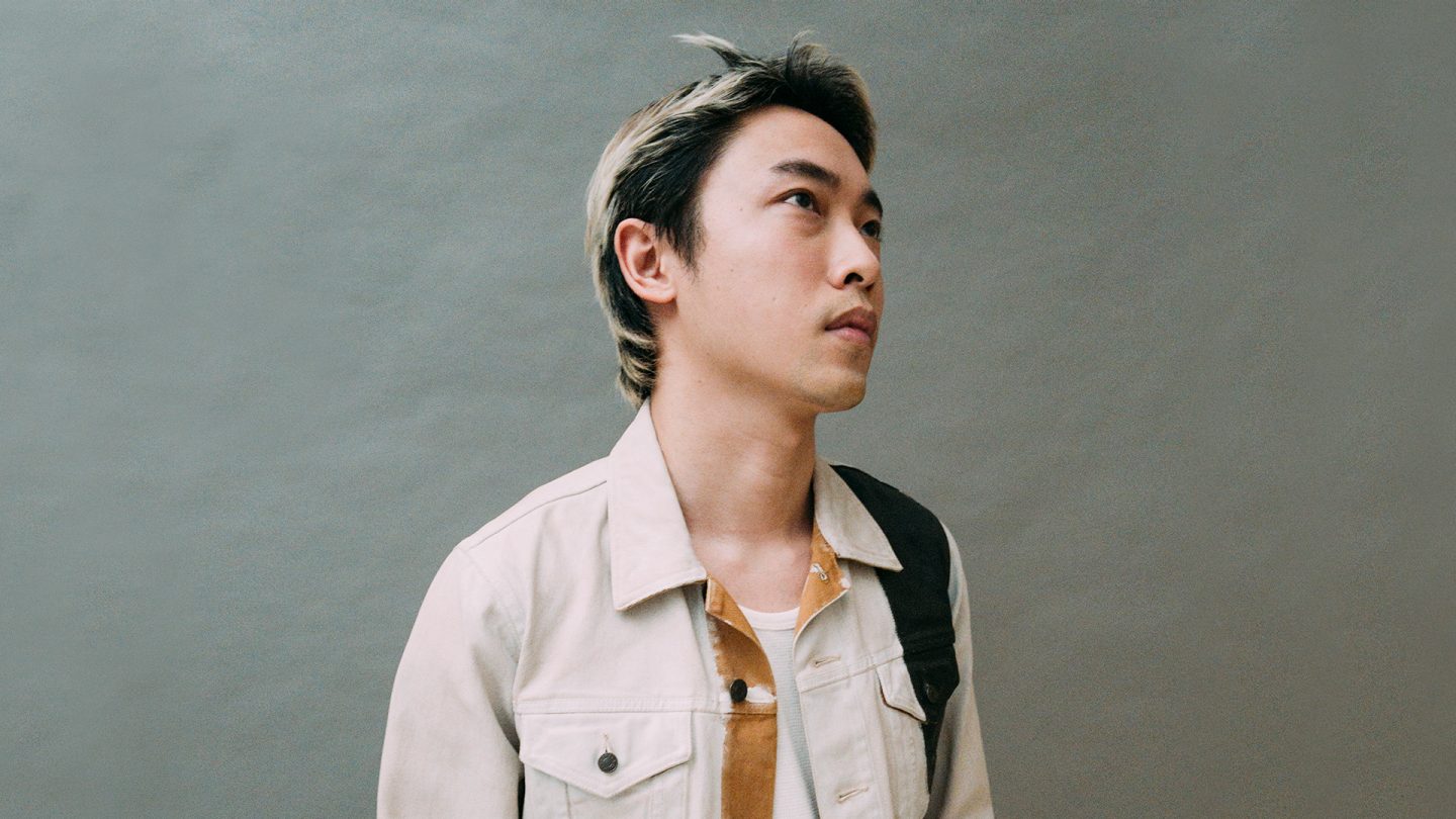 Portrait of Kit Wan with streaked hair in a light jacket