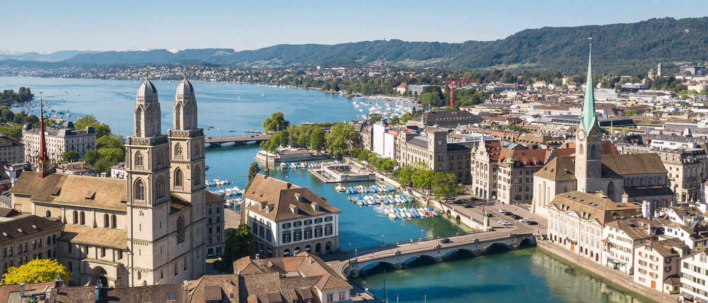 Panoramic view of Zurich cityscape with the Grossmünster church and Limmat River