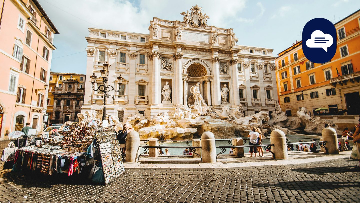 Trevi Fountain in Rome on a sunny day, surrounded by historic buildings