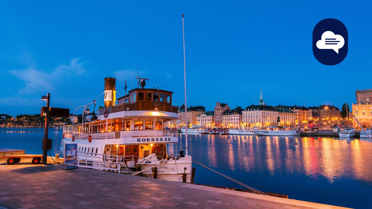 Team Stories: Historic boat at Strömkajen at dusk, Stockholm cityscape in the background